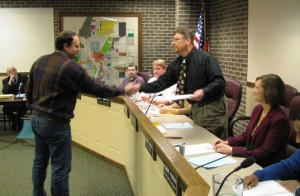 Eric Shafer of Waste Management's Westside Landfill shakes hands with Mayor Allen Balog during presentation of a Certificate of Recognition for donating landfill space for debris from demolition of a building at 110 East Michigan Avenue.  The Three Rivers City Commission has authorized preliminary design work for an East Parking Lot addition on the now vacant site.